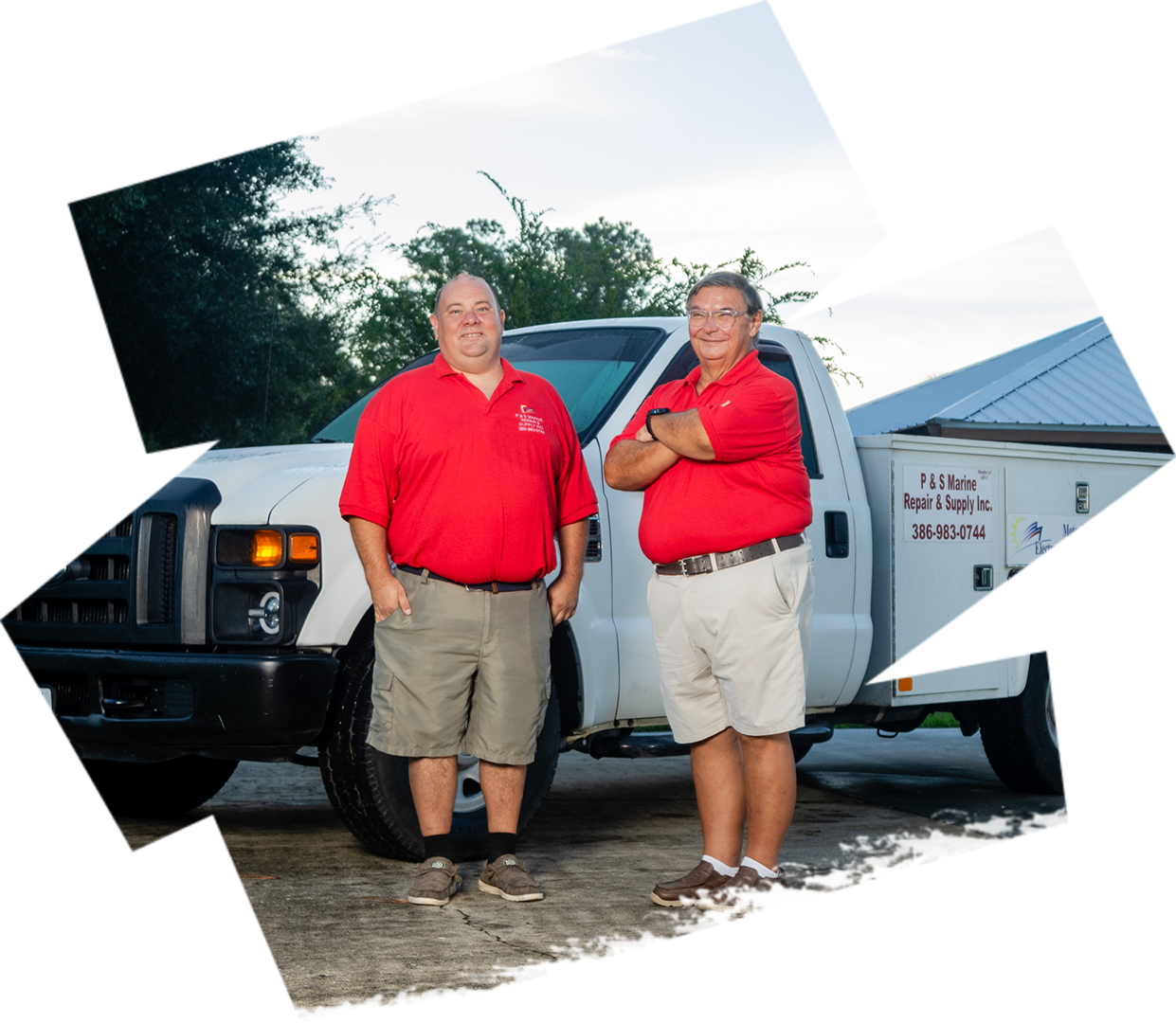 Two men standing in front of a truck.